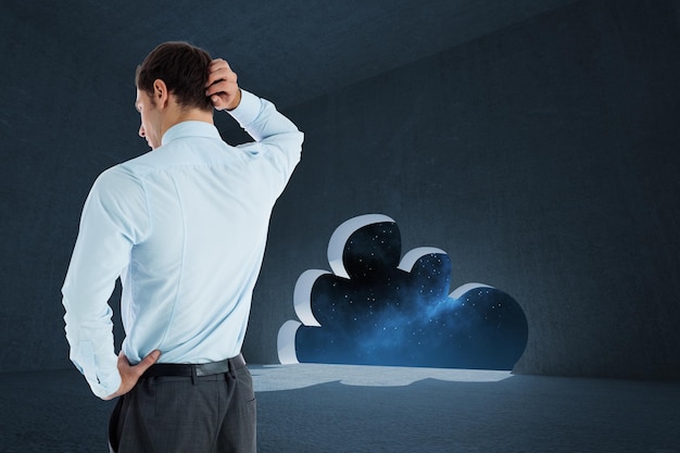 Thinking businessman with hand on head against cloud door in dark room