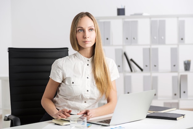 Thinking businesswoman laptop