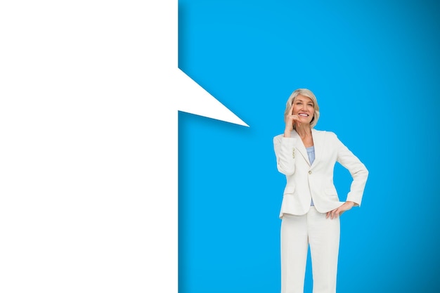 Thinking businesswoman with speech bubble against blue background with vignette