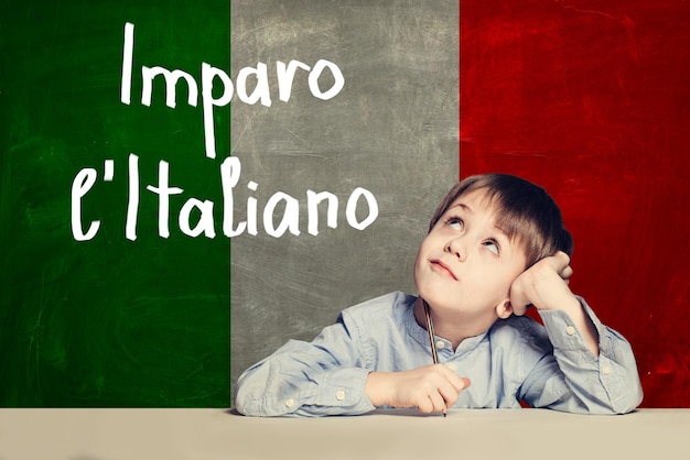 Thinking child boy student against the Italy flag background It
