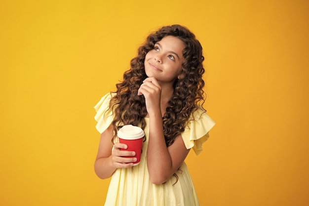 Thinking face thoughtful emotions of school girl holding coffee cup learning and education Coffee break and school recess Back to school Teenager student with plastic takea way cup beverage