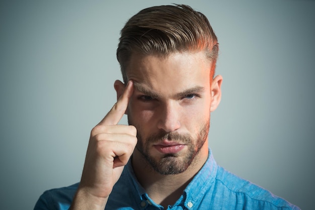 Thinking man smart businessman looking thoughtful while holding his head caucasian man thinking