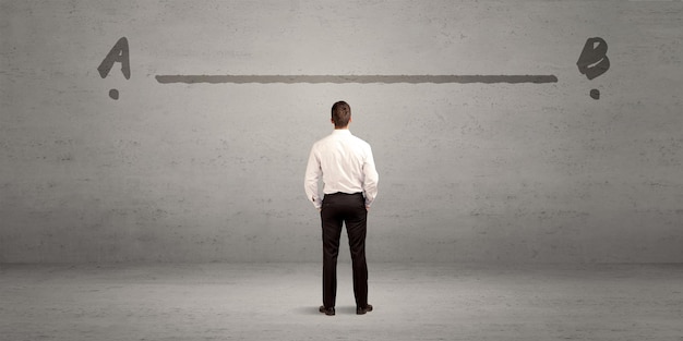 A thinking man who faces both opportunity and challenge stand\
in front of the gray wall