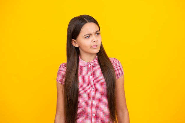 Thinking pensive clever teenager girl Cute young teenager girl against a isolated background Studio portrait of pretty beautiful child