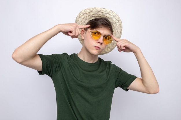 Thinking putting fingers on temples young handsome guy wearing glasses with hat 