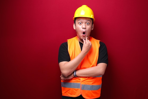 Thinking Young asian man worker is seriously think gesture on red background