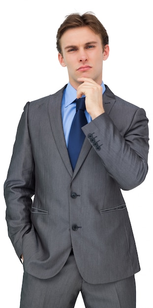 Thinking young businessman in grey suit