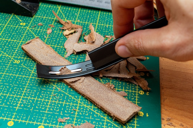 Thinning brown leather stripe with skiver tool. Leather craft hobby