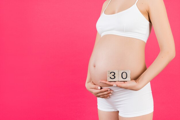 Thirty weeks of pregnancy cubes in pregnant woman's hands