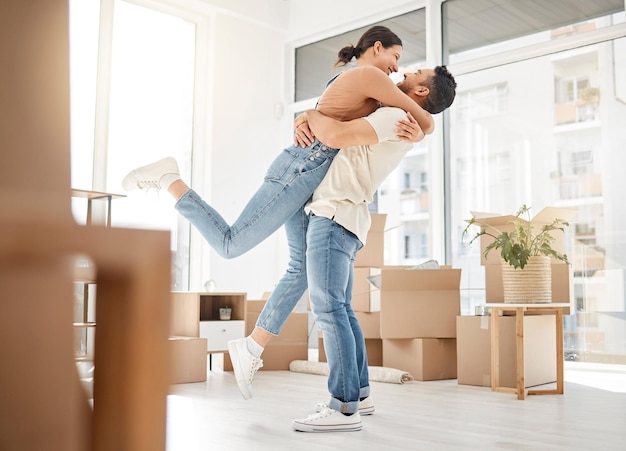 This all feels unreal. Shot of a young couple celebrating the move into their new home.