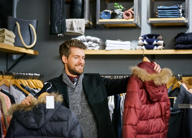 This awesome boutique sells some awesome brands Shot of a young man looking at clothes in a boutique