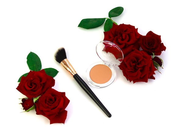 In this composition the contrast between the beauty products and the white background with roses evokes a sense of glamour and elegance