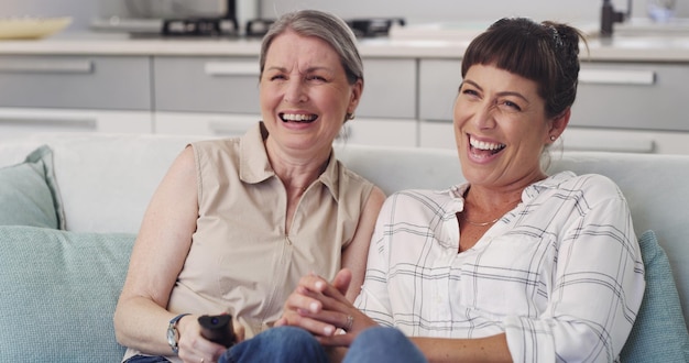 This film is hilarious mom Shot of s mother and daughter enjoying a TV show together