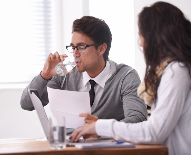 This interview is giving me a dry mouth A young man drinking water during an interview