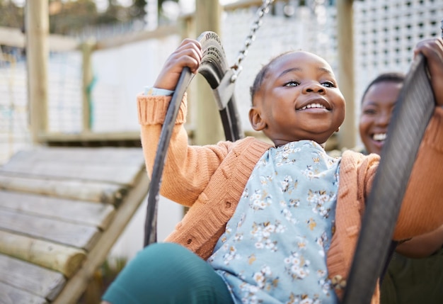 This is the best seat in the world. Shot of a little girl having fun on a swing.