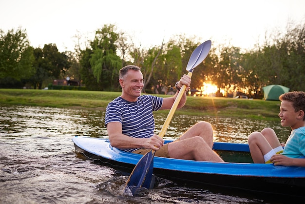 This is the life isnt it son Shot of a father and son rowing a boat together on a lake