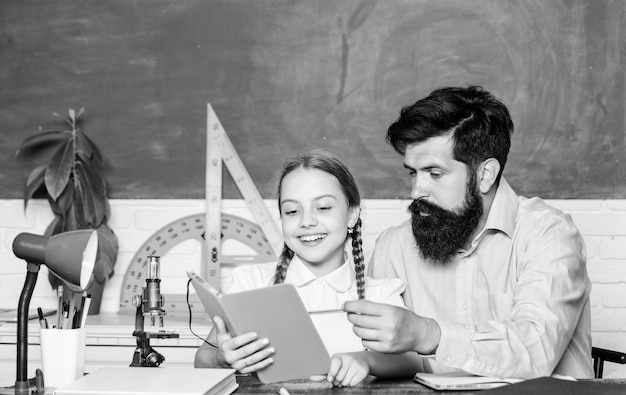 This is my book education and knowledge biology chemistry
lesson bearded man teacher with small girl in classroom father and
daughter study in classroom back to school math geometry