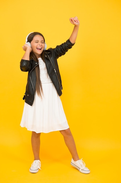 This is my day future pop star child enjoying rhythms be creative and active full of energy happy kid singing listen to music little girl with headphones child having fun childhood happiness