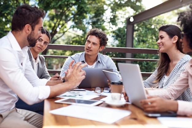 This is my idea Cropped shot of a diverse group of businesspeople sitting together and having a meeting outside the office