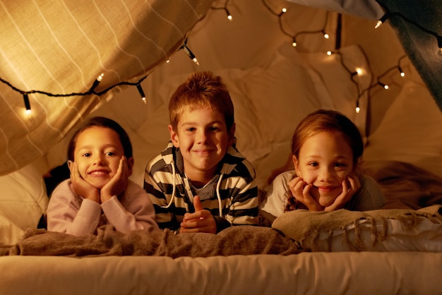 This is our blanket fort shot of three young children in a tent together