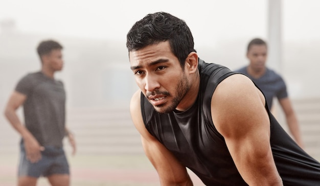 This is the race of your life Shot of a young male athlete catching his breathe during a run