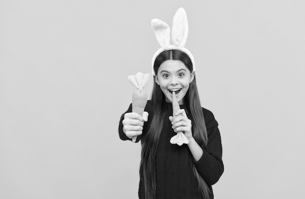 This is for you childhood happiness child in rabbit costume time for fun adorable kid wearing funny hare ears easter spring holiday happy teen girl wear bunny ears bite carrot happy easter