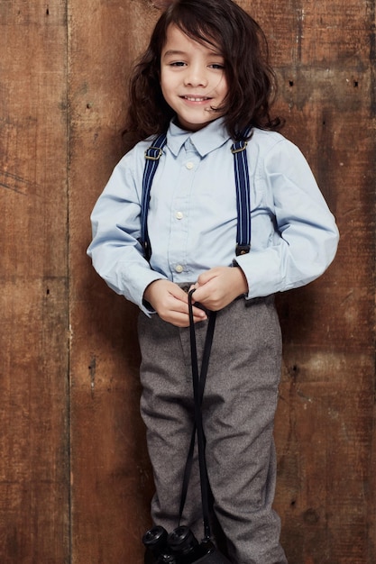 This kid has style shot of a stylish young boy posing in the studio