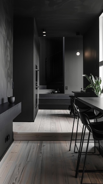 This kitchen exudes a modern elegance with black cabinetry and appliances set against light wood flooring The adjacent dining area blends functionality with style featuring trendy black dining set