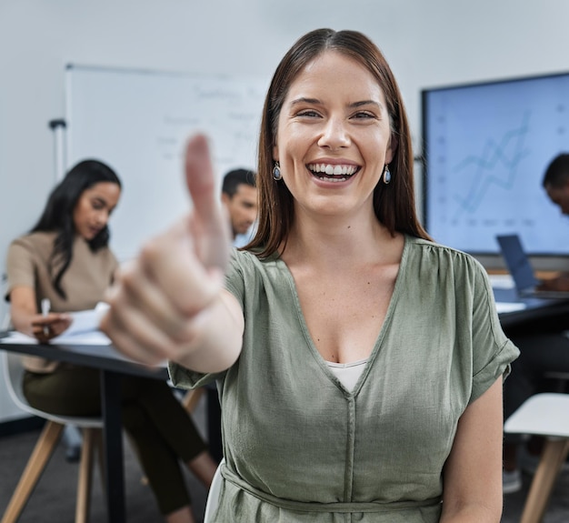 This meeting was so productive Shot of a young businesswoman giving the thumbs up during a successful business meeting