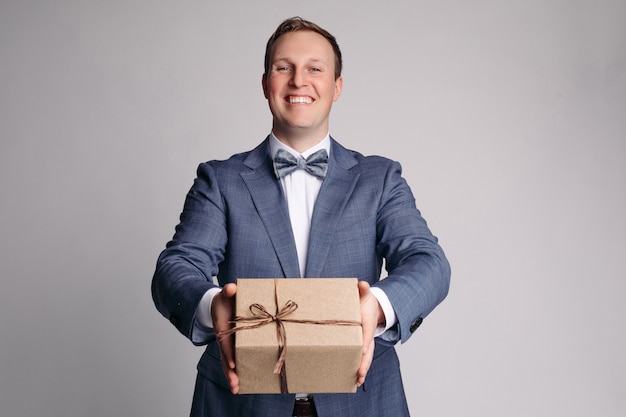 This present is for you Part of man in suit showing present box with smile while standing