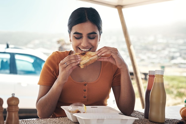 This smells simply mouthwatering Shot of a young woman enjoying some food