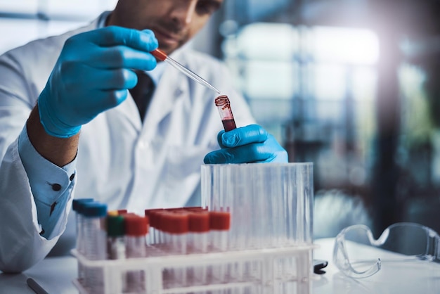 This type of work takes precision Cropped shot of a young male scientist working in a lab