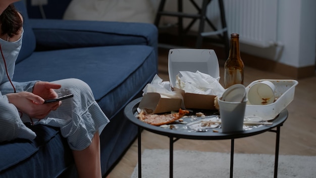 Thoughtful anxious woman listening sad music using smartphone crying feeling lonely worried concerned about problems, pensive depressed person sitting alone grieving thinking of getting loneliness