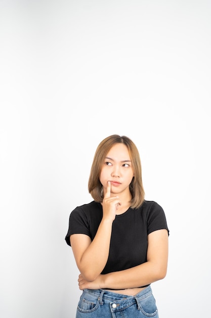 Photo thoughtful asian woman poses against isolated background