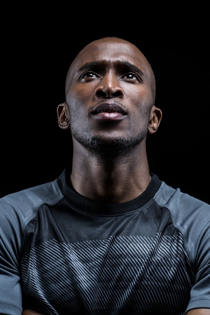 thoughtful athlete against black background