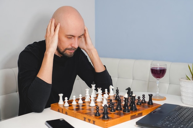 Man playing chess against computer - Stock Image - Everypixel