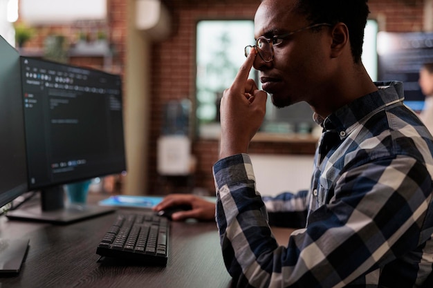 Thoughtful blockchain developer reflecting at low levels of\
security and how to improve mainframe defence system. pensive\
network engineer thinking of failed data processing operation.