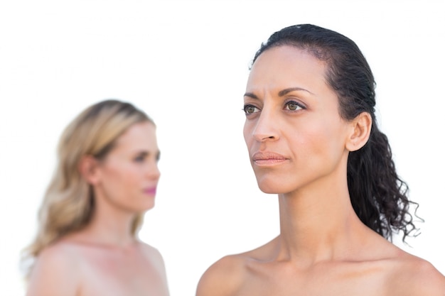 Thoughtful brunette on foreground with blonde on background