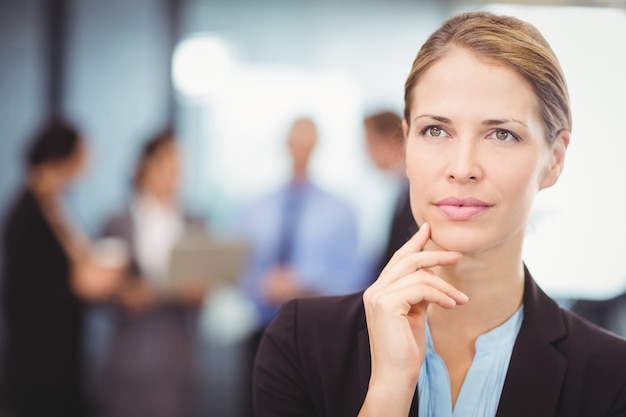 Thoughtful business woman with hand on chin