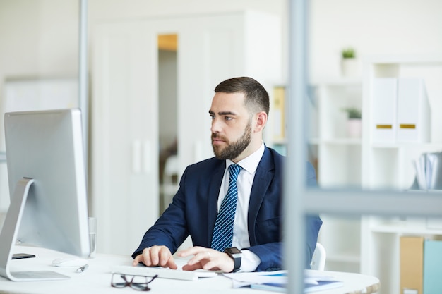 Thoughtful businessman analyzing statistical data