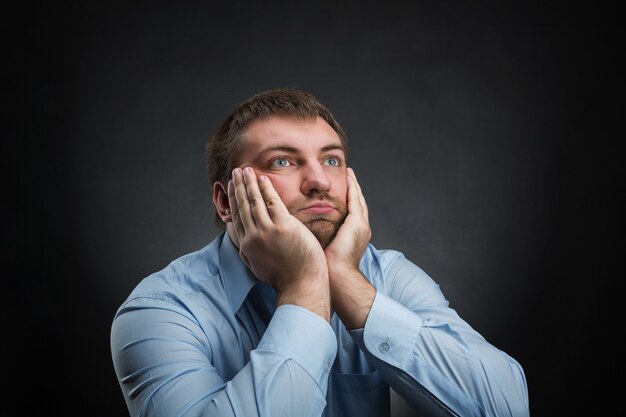 Thoughtful businessman is dreaming about something