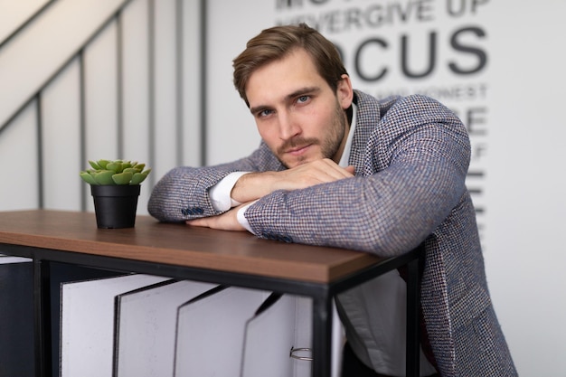 Thoughtful businessman in a jacket in the office