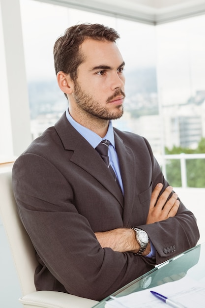 Thoughtful businessman looking away at office