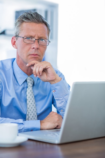 Thoughtful businessman looking at camera 