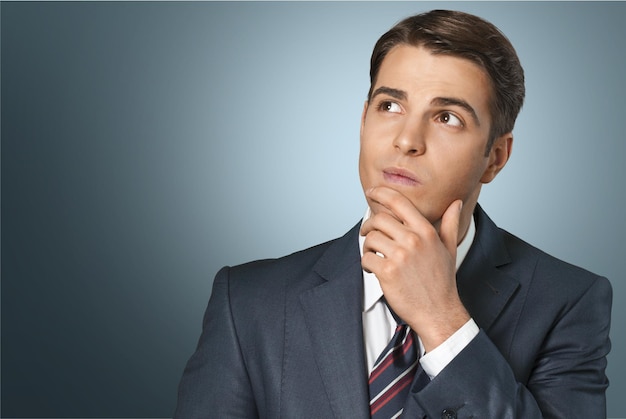 Thoughtful businessman portrait on background