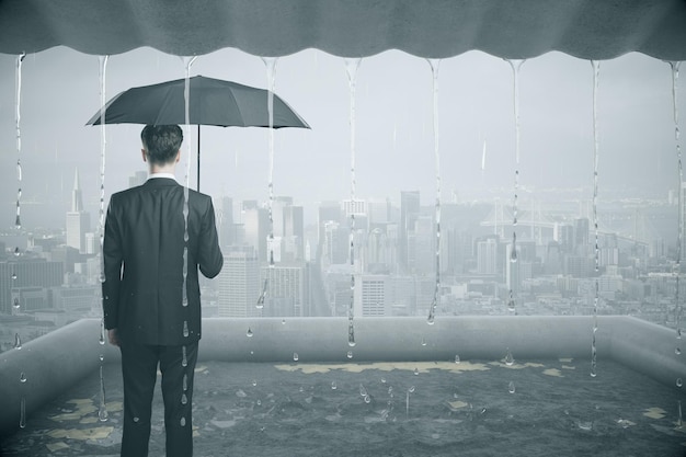 Thoughtful businessman in the rain