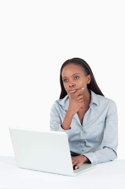 Thoughtful businesswoman using a laptop