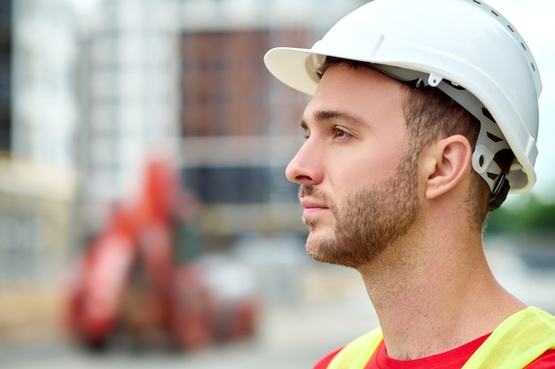 Thoughtful calm handsome bearded Caucasian builder looking away