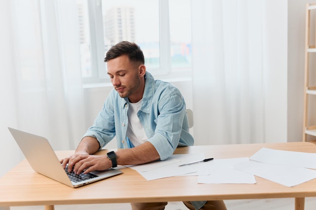 Thoughtful concentrated goodlooking young businessman typing
answer for clients work in call center in office copy space for ad
remote job technology and career profession concept