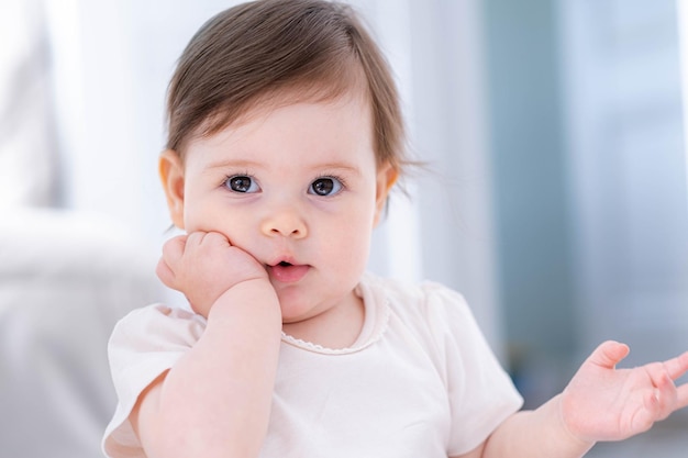 Thoughtful cute little baby girl thinking puzzled of something dreaming or having a good idea smiling and looking up imagination